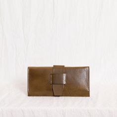 A wallet that is pretty enough to use as a clutch on date night. Six card slots on one side, a zippered pouch for change and receipts and a long pocket that fits a phone. Approximately 8.5" long by 4.5" wide. Closes with our signature leather tabs. Looks great sold as a set with our Siri or Dany. Modern Brown Wallets With Removable Pouch, Brown Rectangular Vegetable Tanned Leather Wallet, Brown Leather-lined Wallet Pouch, Brown Vegetable-tanned Leather Wallets For Everyday Use, Brown Travel Wallet, Rectangular, Autumn Sales, Wallet Accessories, Long Wallet, Card Slots