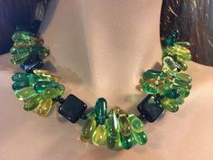 This necklace is made of glass beads in various shades of beautiful green, yellow and black. The combination is stunning!