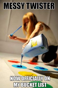 a woman is painting on the floor with paint