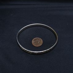 *Description: This is a beautiful silver tone embossed floral Whiting & Davis mid-century bangle bracelet from the 1950s. It would be a great bracelet to give as a vintage gift or wonderful addition to your vintage jewelry collection. *Approximate Measurements: Length Inside of Bracelet - 7 1/2 Inches, Width - 1/4 Inch *Condition: Great vintage condition. Will see signs of wear under magnification. *Hallmark: Whiting & Davis Co *Item # 2692 Please look at the photos carefully as they are Vintage Sterling Silver Bracelet For Anniversary, Vintage Stamped Cuff Bracelet For Wedding, Vintage Hallmarked Sterling Silver Bracelet, Hallmarked Vintage Sterling Silver Bracelet, Vintage Silver Hallmarked Bangle, Antique Silver Vintage Bangle For Formal Occasions, Vintage Sterling Silver Bangle In Antique Silver, Vintage Silver Bangle For Anniversary, Vintage Antique Silver Bangle For Wedding