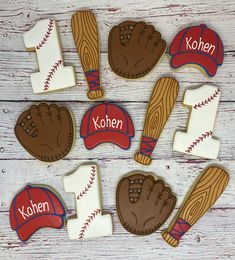 decorated cookies with baseball and mitts on top of a wooden table next to each other