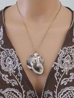 "Vintage Jewelry - Mermaid Jewelry - Mermaid Necklace - Statement Necklace - Beach Necklace - Vintage Brass - Vintage Necklace- handmade This is such an awesome beachy statement necklace! A large beautiful mermaid hangs in front of a shell. Bold and beautiful. The pendant hangs from a pretty vintage ladder chain. USA vintage brass. Chloe says, \"Wear it and feel fabulous!\" The pendant is 2 1/4\" long. You can choose the necklace length you would like at checkout. Thank you for visiting Chloe's" Bohemian Mermaid Necklace For Gifts, Bohemian Mermaid Necklace Gift, Bead Bugs, Tropical Necklace, Vintage Ladder, Mermaid Jewelry, Vintage Jewelry Art, French Jewelry, Bainbridge Island