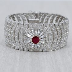 A breathtaking Art Deco style bracelet featuring a Burmese Ruby center stone. Masterfully hand-crafted in 18k White Gold. Feauting 13.21cts of Si-i1 Diamonds. Gemstone Details: Featuring a magnificent Burmese Ruby 2.24ct hearted round Carat Weight: 2.24 carat This stunning Ruby Diamond Bracelet is only available at Burdeen's Jewelry. Great gift idea for wedding or anniversary! We have many unique offerings of period fine jewelry posted on our Etsy store. Consider browsing all styles. Call us tod Ruby Diamond Bracelet, Gift Idea For Wedding, Burmese Ruby, Jewelry Post, Art Deco Diamond, Ruby Diamond, Burmese, Art Deco Style, Style Art