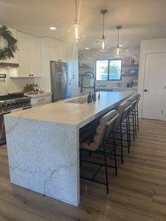 a large kitchen with an island in the middle and lots of counter space on one side