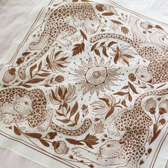 a white table cloth with brown designs on it