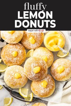 lemon donuts with powdered sugar on top and lemon slices around the doughnuts