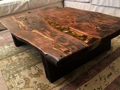 a wooden table sitting on top of a rug next to a couch