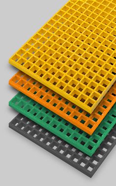 four different colored plastic grates stacked on top of each other in order to create an interesting pattern