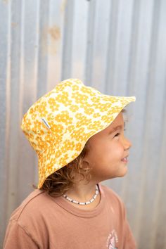 Protect your keiki in style with our Aloha Xchng Kids Puakenikeni Reversible Bucket Hat! With two hats in one, you will find our patch on the solid colored side and our custom Puakenikeni print on the other. Comes with a velcro chin strap to keep on tightly. Sizing: Mini - Newborn - 12 Months Biggie - 1-2 yrs old Designed on Kauai, Hawaii Reversible One Size Fits Most Bucket Hat, Reversible Cap Sun Hat For Beach, Reversible Bucket Hat For Vacation, Playful Bucket Hat With Short Brim, One Size, Reversible Beach Sun Hat Cap, Reversible Bucket Hat One Size, Reversible Bucket Hat With Short Brim, Casual Reversible Hats, One Size, Playful Sun Hat With Curved Brim For Festivals