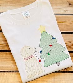 Excited to share this item from my #etsy shop: Personalized Christma Puppy Christmas Lights Shirt~Christmas Tree Shirt~1st Christmas #christmas #sketchembroidery #personalizedshirt #siblingshirt #christmaspuppy White Tops With Custom Embroidery For Christmas, Christmas Shirt Monogram, Christmas Applique Shirts, Embroidery Christmas Shirts For Boys, Christmas Tree Monogram Shirt, Christmas Tree Shirt, Sibling Shirts, Christmas Embroidery Designs, Christmas Puppy