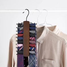 a tie rack with ties hanging from it's hangers next to a shirt