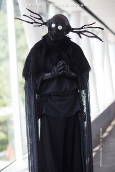 a man dressed as a demon with long black hair