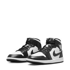 Keep heritage on your feet with a white-and-black look that will never go out of style. The women's Air Jordan 1 Mid brings full-court style and premium comfort to an iconic look. Its Air-Sole unit cushions play on the hardwood, while the padded collar gives you a supportive feel. Never miss a beat with a classic like the AJ1 Mid. Features: Specifically designed with women's sizing and fit in mind, providing a more tailored and comfortable experience. Genuine and synthetic leathers provide superior durability and style. Padded tongue and inner upper for added comfort and security. Iconic winged Air Jordan logo on the upper for traditional branding. Encapsulated Air unit in the heel gives the lightweight cushioning you know and love. Solid rubber outsole with tread for standard traction. St Jordan 1 Mid Women, Wing Logo, Jordan 1 Mid White, Sportswear Men, Jordan Model, Jordan Logo, Womens Basketball Shoes, Yeezy Sneakers, Womens Air Jordans