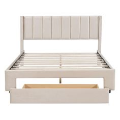 a white bed frame with two drawers underneath it and the headboard is upholstered