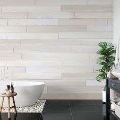 a white bath tub sitting next to a wooden table