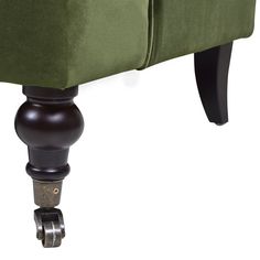 an upholstered green couch with wheels on the bottom and armrests down