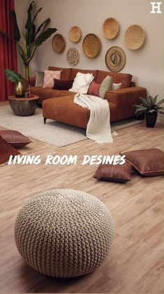 a living room filled with lots of furniture and pillows on top of wooden flooring