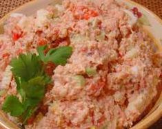 a bowl filled with meat and garnish on top of a table