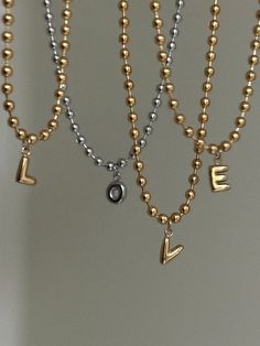 "Mini Bubble Letter Necklace ✨ Capital letter initial of your choice paired with a steel (18k gold plated) ball chain. Customizable length (if you need a length that isn't an option in the dropdown menu, please message me!) I'm also happy to make other customizations if necessary ✨☺️ Letter pendants are 1/4\" (.25\")  Unisex//Hypoallergenic~ tarnish proof and can be worn everyday!  Handmade with love" Gold Initial Necklace With Letter Beads For Anniversary, Gold Metal Jewelry With Letter Beads, Valentine's Day Gift Ball Chain Necklace, Gold Charm Necklaces With Letter Beads, Minimalist Gold Charm Necklaces With Letter Beads, Gold Minimalist Charm Necklace With Letter Beads, Minimalist Gold Charm Necklace With Letter Beads, Gold Anniversary Letter Beads Necklace, Gold Charm Necklace With Letter Beads For Anniversary