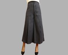 * A wool skirt pants, fixed waist with a button and a zipper.  * A flowing design of skirt shaped woolen pants with wide leg.  * Materials: 30% wool, 20% cotton, 50% polyseter Shop sizing chart FYI ( actual body figures, not laying flat clothes measurements) Size XS (US 2, UK 6, German 32, French 34) Bust: fits bust around 33.5 inches/85cm Waist: fits waist around 26 inches/66cm Hips: fits hips around 36 inches/91cm Size S (US 6, UK 10, German 36, French 38) Bust: fits bust around 35.5 inches/90 Chic Full-length Wool Bottoms, Fitted Wool Wide-leg Bottoms, Winter Full-length Wool Pants, Grey Wool Wide Leg Pants, Wool Wide-leg Pants With Pockets, Loose Pants Women, Women Trousers, Body Figure, Pants Loose