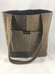 a brown and black bag sitting on top of a white table