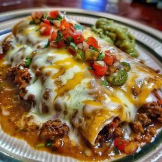 an enchilada with meat and vegetables on a plate