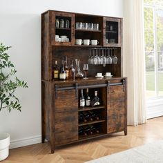 a wooden cabinet with wine glasses and liquor bottles