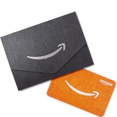 an orange amazon gift card with the amazon logo on it next to a black envelope