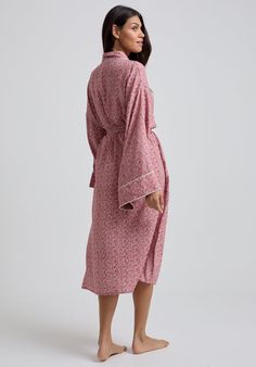 The charming Corina robe is cut from our inimitable cotton and adorned with an interesting pink Ditsy floral print. This oversized kimono-inspired robe boasts fluted sleeves and a detachable belt, creating a flattering silhouette. Contrast piping on the cuff and neck, complete this effortlessly feminine piece.  Cool machine wash only. Wash inside out and with similar colours 100% Cotton Sourced India  Cool machine wash only. Wash inside out and with similar colours Oversized Kimono, Fluted Sleeves, Luxury Scarves, Printed Robe, Floral Robes, July Birthstone Jewelry, Ditsy Floral Print, Nightwear Women, Contrast Piping