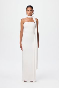 Simplicity meets sophistication in our vacay-inspired set. Designed with a tube and double-lined bodycon structure with a detachable scarf to wrap around your head or relax along your arms. Smooth Collection Import 92% Viscose Rayon, 8% Spandex Model wears size X-Small True to size Double-lined Elegant White Maxi Dress, White Scarf Dress, Formal Dress With Scarf, White Dress With Scarf, Luxury Chic Draped Strapless Dress, Luxury White Bandeau Dress, Fitted Strapless Pre-draped Maxi Dress, Elegant White Bandeau Maxi Dress, White Strapless Stretch Maxi Dress