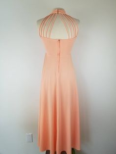 "Gorgeous 1970s maxi dress with the coolest cage neckline. This dress is professionally made but the tags have been cut off. Dress closes with a 11 inch nylon zipper center back. Fabric is a nylon or polyester with a reasonable amount of stretch. Condition - Excellent, with no issues to note. Measurements - For reference the dress form measures B35 W25. The dress is an excellent fit on the dress form and is about the largest measurements I would recommend. Bust - 34/35\" Under bust - Up to 28\" 70s Halter, Maxi Dress 70s, Gunne Sax Dress, Dress 70s, Disco Dress, Halter Maxi Dress, Halter Maxi, 60s Dress, 70s Dress