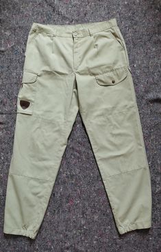 Cool vintage cargo hiking pants. Material is a mix of synthetics and cotton 5 pockets Adjustable leg openings  Light and functional Double layer on the knees Size M/L(please check measurements) For a person 180 cm +  Full length 110 cm In seam 82 cm Waist 47 cm Hip 59 cm Front rise 30.5 cm Tiny not eye catching stains present due to age and light color Adjustable Legs, Hiking Pants, Cool Vintage, Latvia, Cargo Pants, Double Layer, Gender Neutral, Full Length, Adult Outfits