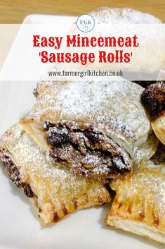 some pastries are on a white plate with powdered sugar over them and the words easy minemeat sausage rolls