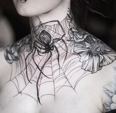 a woman with spider web tattoo on her chest