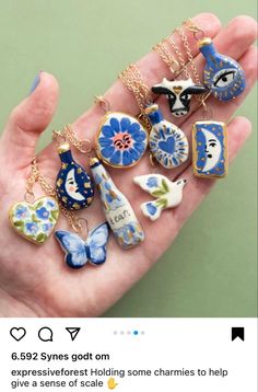 a hand holding a bunch of different types of necklaces on it's fingers