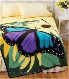 a crocheted blanket with a butterfly on it