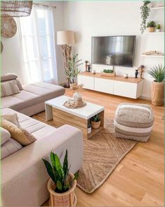 a living room filled with furniture and a flat screen tv on top of a wooden table