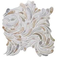 a white and brown tile design with wavy lines on it's face, in the shape of a leaf