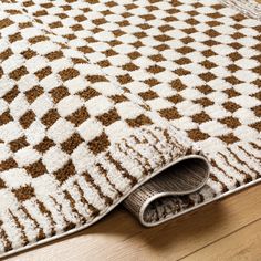 a brown and white rug on the floor