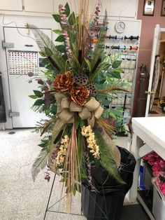 an arrangement of flowers and plants in a flower shop