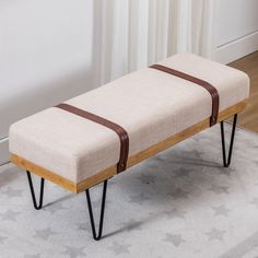 a wooden bench with hairpin legs on a rug