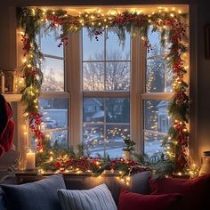 a living room window decorated with christmas garland and lights