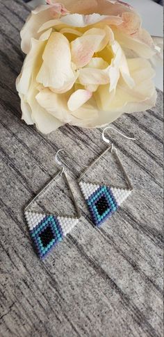 Deep dark centers pop on these pretty patterns. Blue black hex beads are flanked by a crisp seafoam blue and dark lavender. Woven onto silver plated triangles and finished with sterling silver ear wires.Made to order. Not available for wholesale. Adjustable Geometric Beaded Jewelry, Unique Handmade Geometric Earrings, Blue Bohemian Triangle Earrings, Bohemian Blue Triangle Earrings, Handmade White Triangle Beaded Earrings, Triangle Beaded Earrings For Gifts, Beaded Triangle Earrings For Gifts, Handmade Blue Geometric Earrings, Handmade Geometric Sterling Silver Jewelry