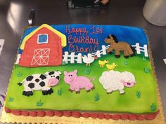 a birthday cake with farm animals on it