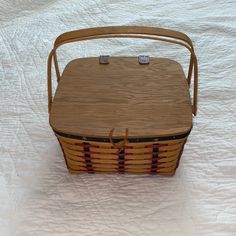 a wooden basket sitting on top of a bed