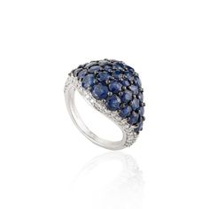 This is part of Chairish’s Fine Jewelry assortment.  Natural Diamond and 4.64 CTW Blue Sapphire Cluster Dome Ring in 18K Gold featuring natural blue sapphire of 4.64 carat and diamonds of 0.61 carats. The gorgeous handcrafted ring goes with every style. Sapphire stimulates concentration and reduces stress. Designed with round sapphires cluster in center with diamonds set in corners of the ring that makes it a perfect fit to wear it on your occasion or style it with any of your basic outfit to gi Luxury Sapphire Multi-stone Diamond Ring, Luxury Sapphire Birthstone Ring, Luxury Sapphire Cluster Ring, Luxury Blue Diamond Ring With Pave Setting, Luxury Sapphire Diamond Ring With Gemstone, Blue Luxury Diamond Ring With Rose Cut Diamonds, Blue Sapphire Ring With Pave Setting For Formal Occasions, Luxury Blue Diamond Ring With Rose Cut, Blue Sapphire Ring With Pave Setting