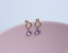 Dainty stud earrings handcrafted from 14 gold-filled wire and adorned with little briolette drops of pink amethyst for an extra feminine and delicate touch. Elevate your elegance with our delicate handmade drop earrings. Featuring a 14k gold-filled stud, these earrings are graced by a petite pink amethyst faceted briolette that sways gracefully, capturing and reflecting light with each movement - a touch of elegance that's impossible to ignore. Designed to add a touch of refinement to any ensemble, these earrings effortlessly enhance your look, making it delicate and special. Secured with a gold-filled butterfly clasp, they offer both comfort and sophistication. Whether for yourself, a cherished bridesmaid, or a thoughtful gift for mom or wife, these earrings encapsulate femininity and gra Dainty Handmade Briolette Earrings, Dainty Briolette Earrings Handmade, Handmade Briolette Earrings In Minimalist Style, Delicate 14k Gold Filled Briolette Earrings, Delicate Briolette 14k Gold Filled Earrings, Dainty Briolette Earrings With Ear Wire, Dainty Teardrop Earrings, Light Earrings, Dainty Studs