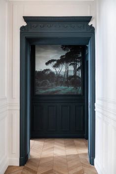 an open door leading to a painting on the wall