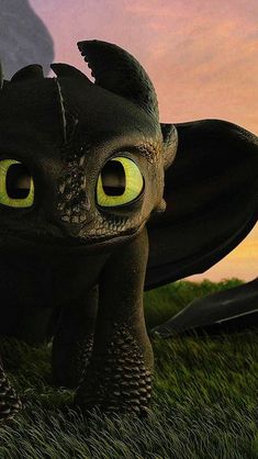 a close up of a toothless dragon in the grass