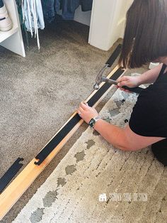 a woman is working on a piece of furniture